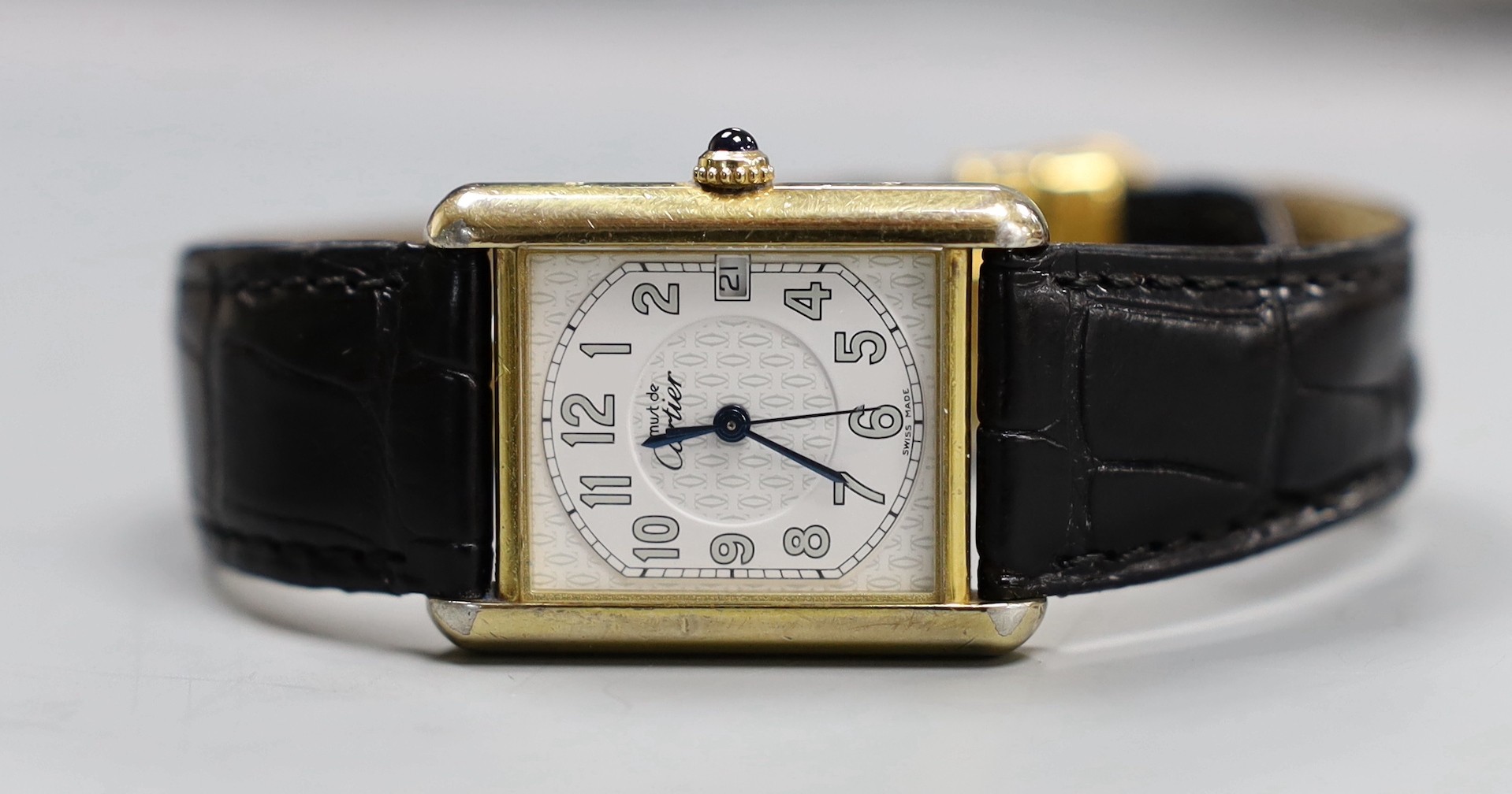A Must de Cartier silver gilt quartz Tank wristwatch, with date aperture, and blue cabochon winder
